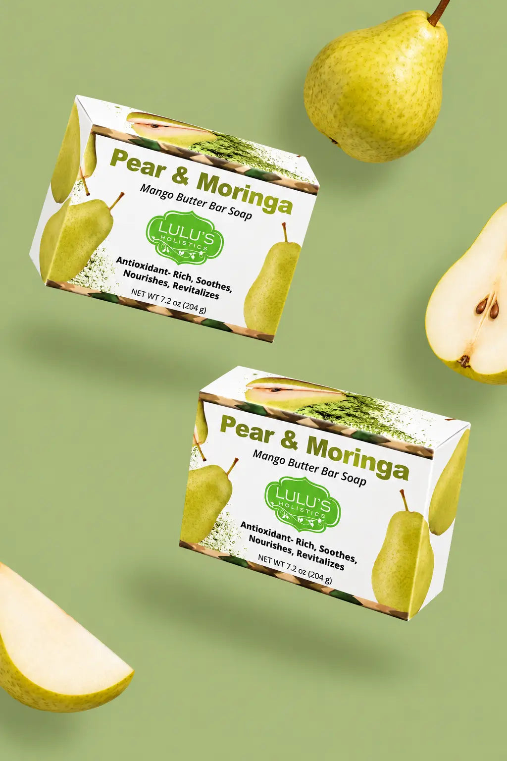 Video laden: Professional marketing video featuring two floating boxes of Lulu's Holistics Pear and Moringa Mango Butter Bar Soap with falling organic pear slices on a muted olive green background