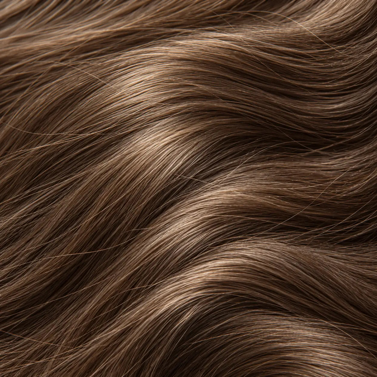 Close-up of smooth, hydrated wavy hair after using Lulu's Holistics Vital hair care products.