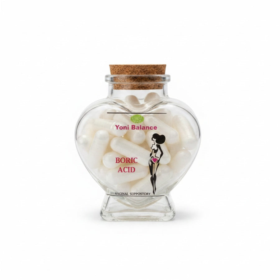 Lulu's Holistics Yoni Balance Boric Acid Suppositories in a heart-shaped glass bottle with cork stopper.