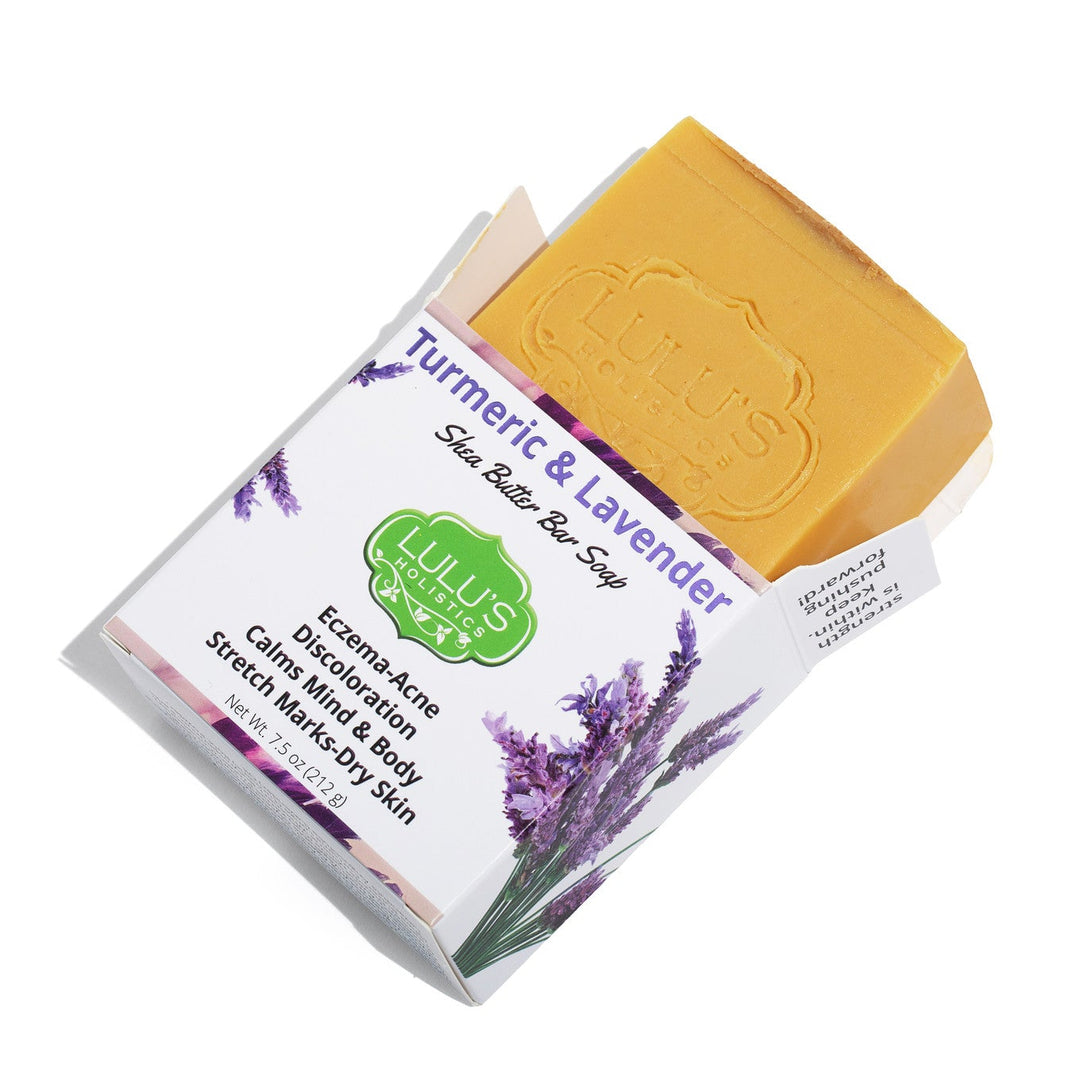 Lulu's Holistics Turmeric and Lavender Shea Butter Bar Soap displayed with raw natural ingredients. Shop this gentle, brightening cleanse online to naturally fade dark spots and calm sensitive skin globally.