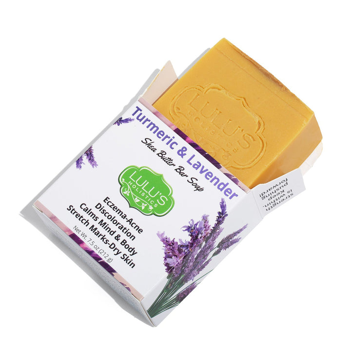 Lulu's Holistics Turmeric and Lavender Shea Butter Bar Soap displayed with raw natural ingredients. Shop this gentle, brightening cleanse online to naturally fade dark spots and calm sensitive skin globally.